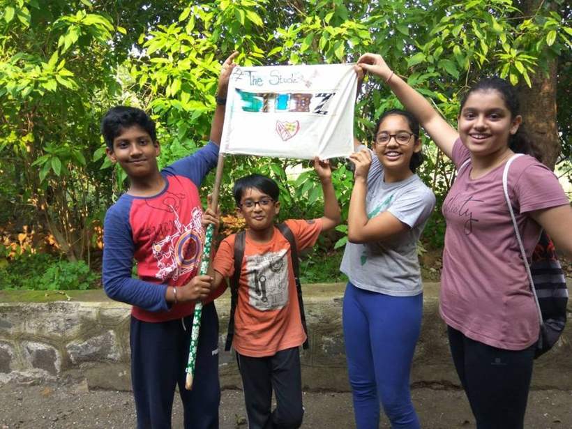 Campers holding up their team flag