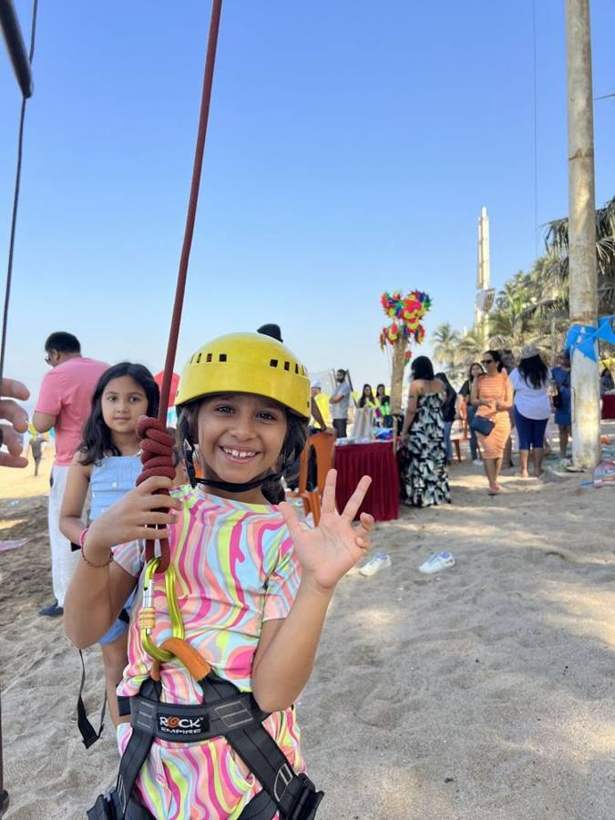 A smiling girl in a helmet ready for the zipline